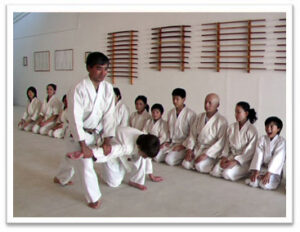 Photo of Senpai Gary Okuma with children -- at Mumonkan-Do Aikido -- Founded by Sensei Lori Parker