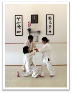 Photo of Senpai Gary Okuma with children -- at Mumonkan-Do Aikido -- Founded by Sensei Lori Parker
