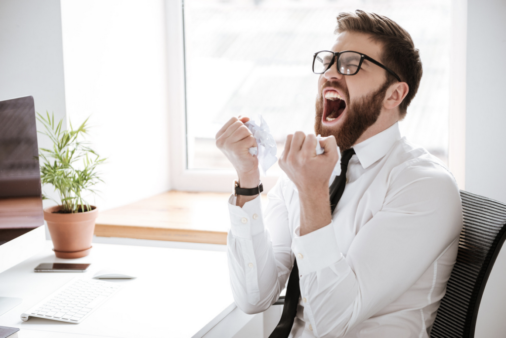 Image of man VERY frustrated. Helps one to get a sense of what life is like in a "sympathetic state" -- one of two signs of a dysregulated Autonomic Nervous System. Safe & Sound Protocol serves to bring one back into a more balanced ANS state.