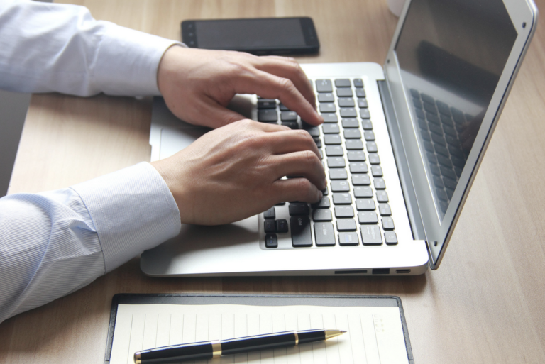 A man typing to suggest he is writing a testimonial for the Embodied Mindfulness Method