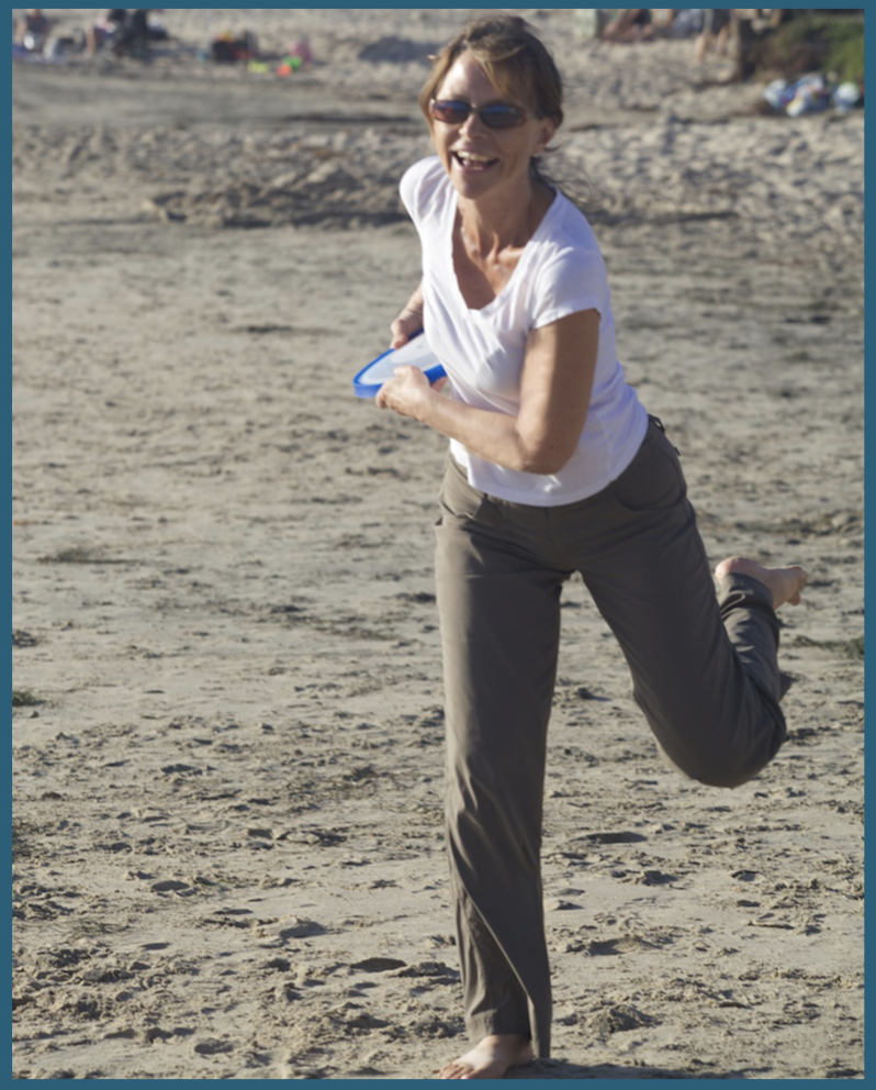 Image of the Feldenkrais teacher throwing a frisbee on a beach to show that you CAN stay active as you age.