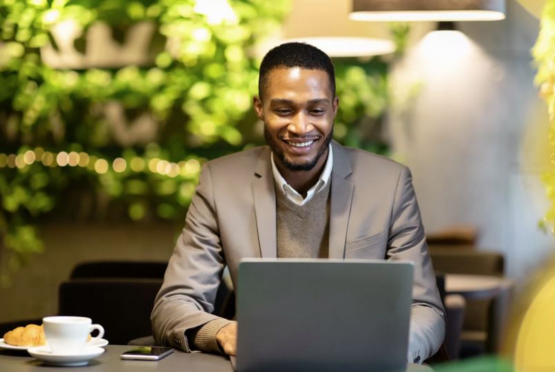 A man sending an email from a laptop computer