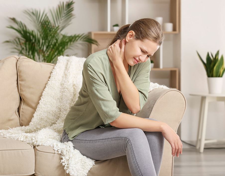 A woman experiencing pain in her neck