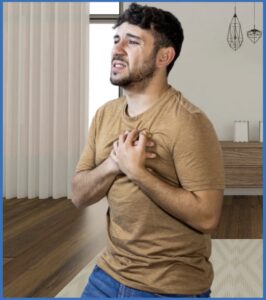 A man clutching his chest