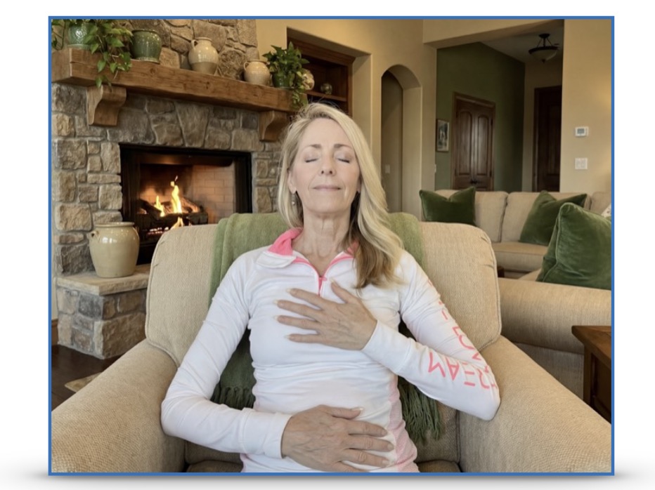 A woman placing a hand on heart and a hand on her abdomen