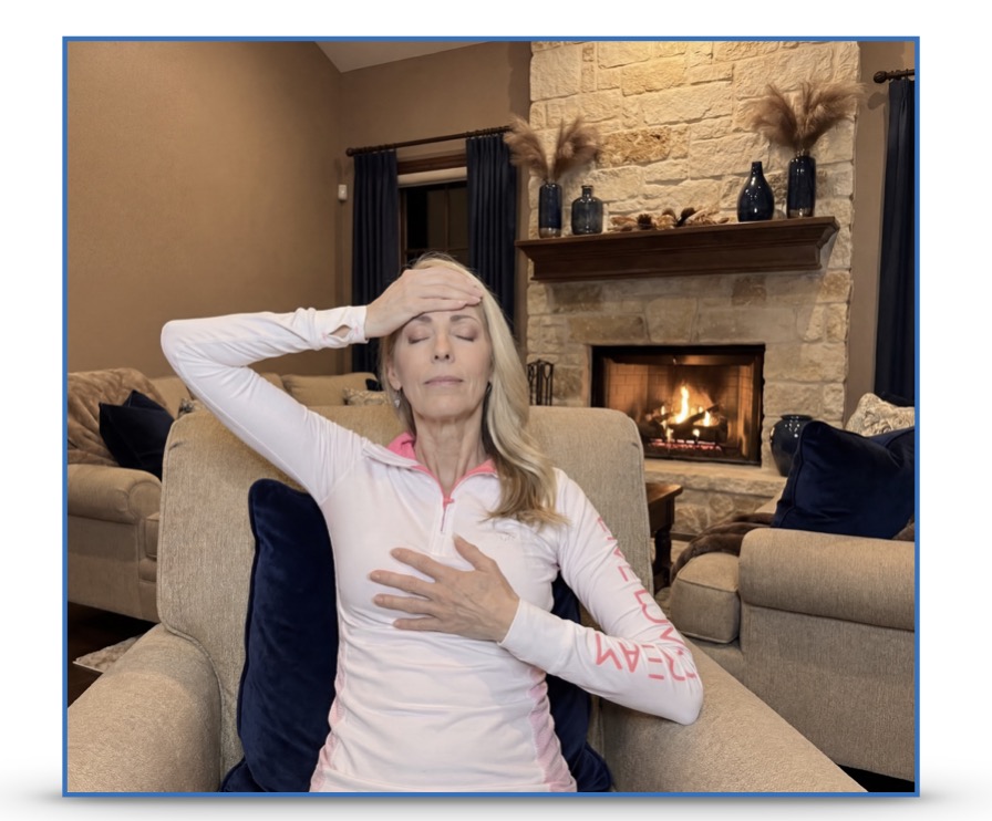 A woman placing a hand on her forehead and a hand on her heart