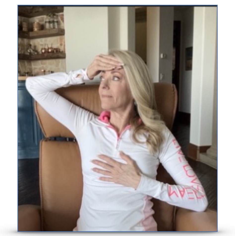 A woman placing a hand on her forehead and a hand on her heart