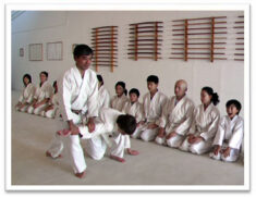 Photo of Senpai Gary Okuma with children -- at Mumonkan-Do Aikido -- Founded by Sensei Lori Parker